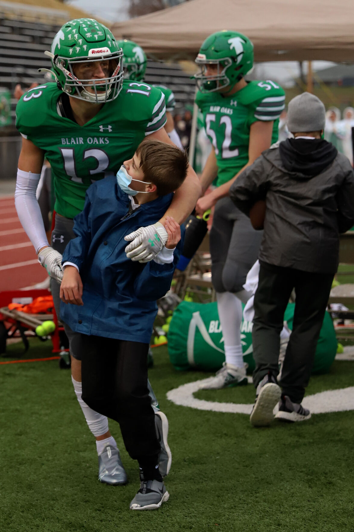 Sam Closser, 13, right, looks up at senior Carson Prenger